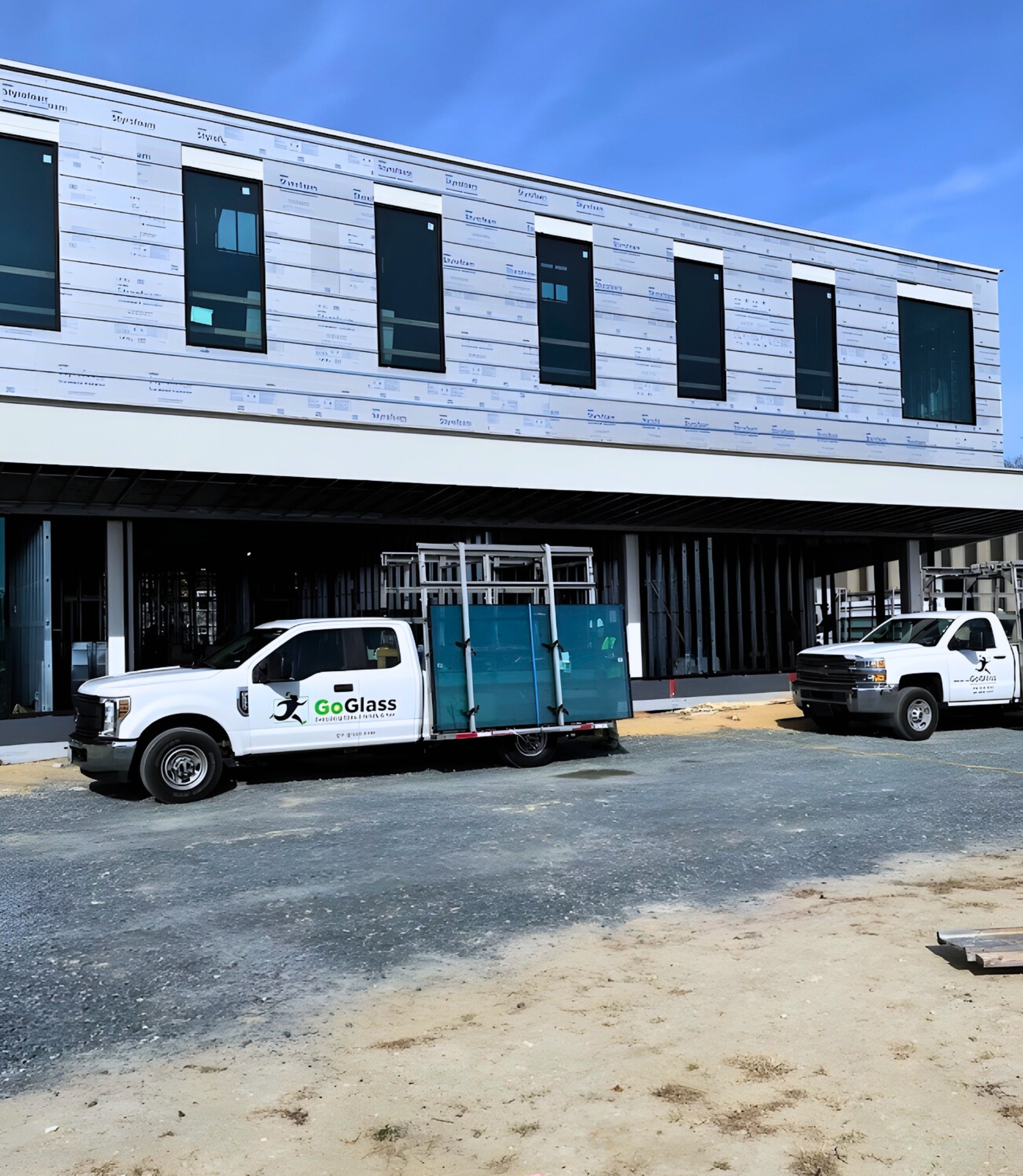 Commercial Storefront and commercial windows being installed with two GoGlass trucks out front