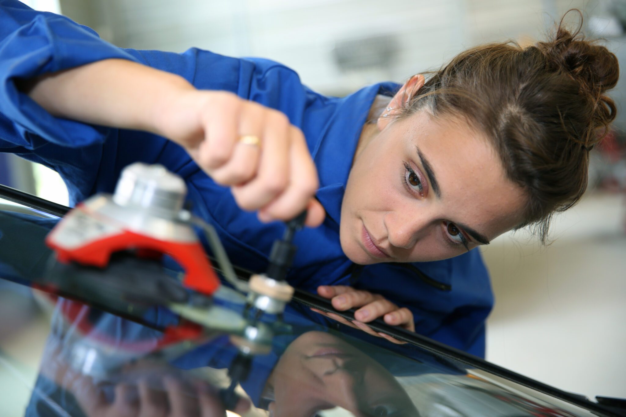 Closeup of contractor installing windshield glass